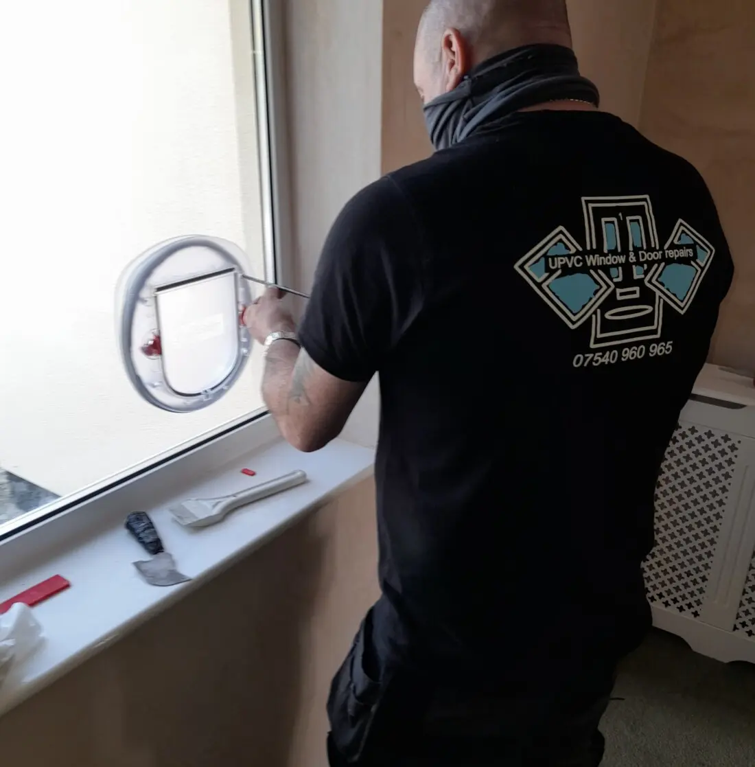 Cat flap fitted into a window. Cat flap fitter.